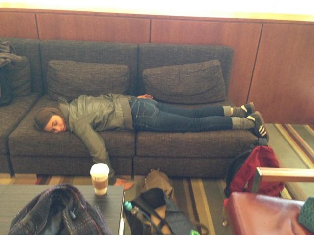 Collapsed on a hotel couch from conference exhaustion.